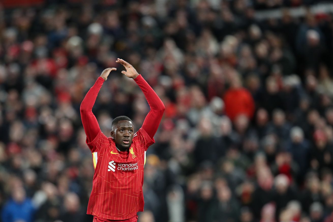 Ibrahima Konate of Liverpool gestures to get the home crowd going during the UEFA Champions League 2024/25 Round of 16 Second Leg match between Liverpool FC and Paris Saint-Germain at Anfield on March 11, 2025 in Liverpool, England