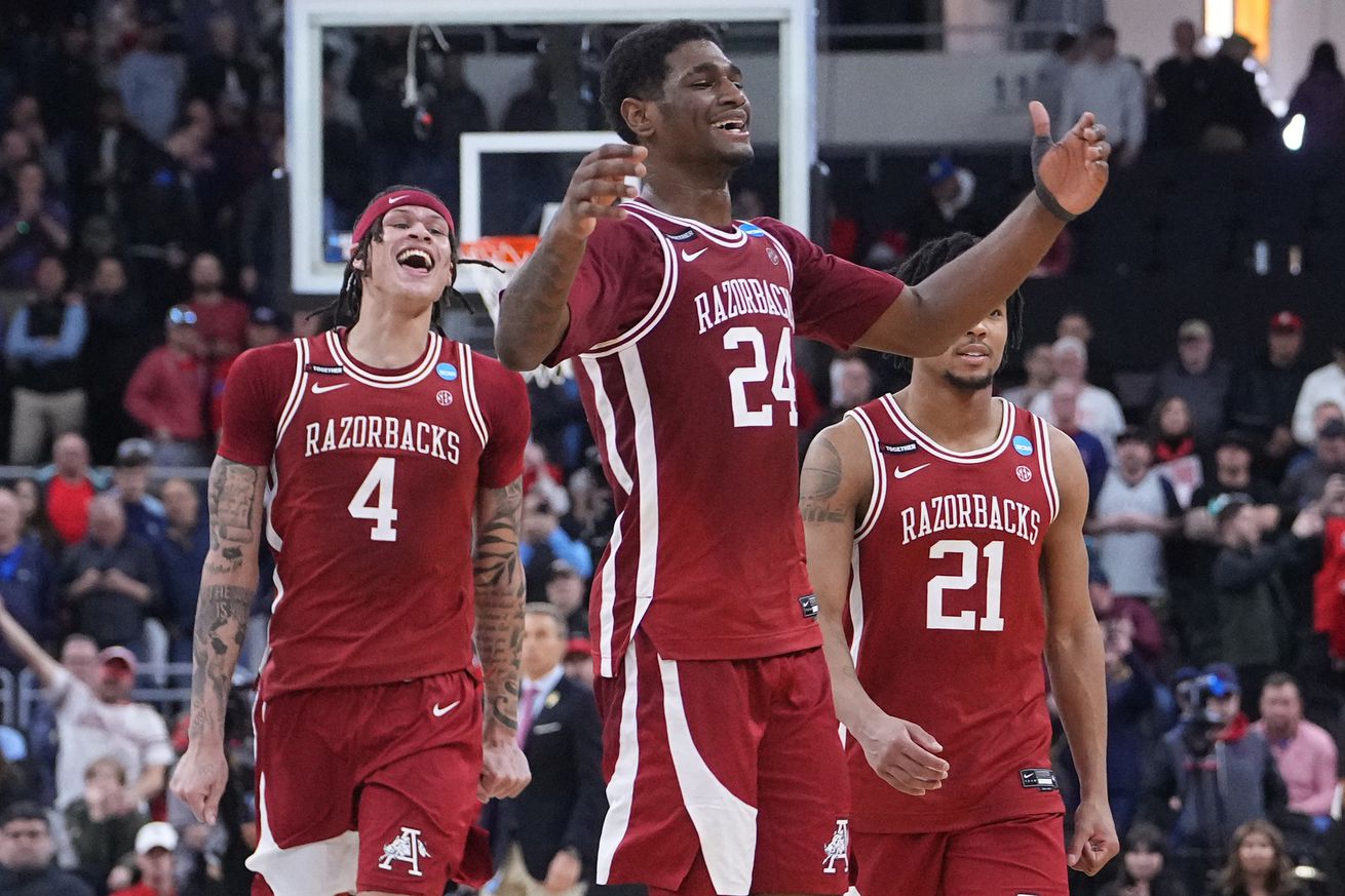 Arkansas Razorbacks forward Trevon Brazile (4), forward Billy Richmond III (24) and guard D.J. Wagner (21) celebrate after defeating the St. John’s Red Storm in a second round men’s NCAA Tournament game at Amica Mutual Pavilion.