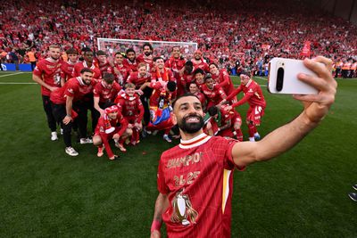Mohamed Salah of Liverpool taking a selfie with his team mates celebrating after being named champions of the Premier League at the end of the Premier League match between Liverpool FC and Tottenham Hotspur FC at Anfield on April 27, 2025 in Liverpool, England.