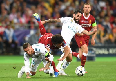 Mohamed Salah of Liverpool falls and lands on his shoulder after a collision with Sergio Ramos of Real Madrid, leading to him going off injured during the UEFA Champions League Final between Real Madrid and Liverpool at NSC Olimpiyskiy Stadium on May 26, 2018 in Kiev, Ukraine.